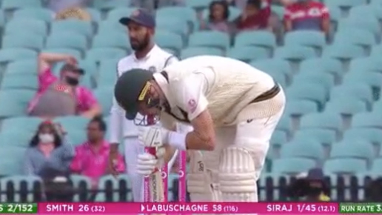 Marnus Labuschagne attends to his grip.