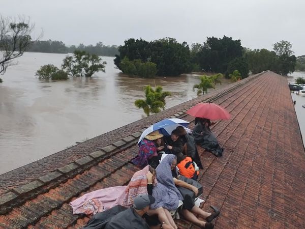 Residents trapped on roof of a Lismore lodge. They were rescued by a helicopter. Source: 9 News