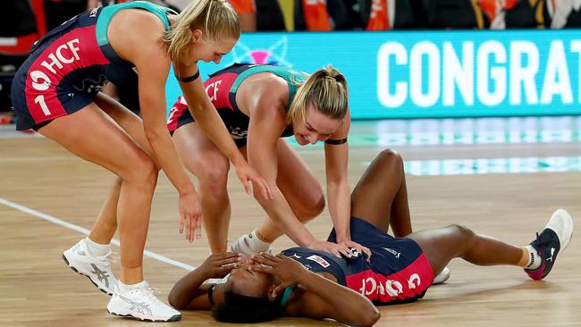 Kate Moloney and Liz Watson rush to Mwai Kumwenda after the stunning victory. Picture: Kelly Defina/Getty Images