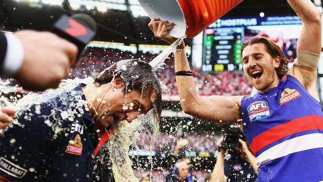 Luke Beveridge is drenched by Marcus Bontempelli during the post-match celebrations. Picture: Getty Images.