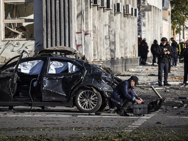 KYIV, UKRAINE - OCTOBER 10: Emergency service personnel attend to the site of a blast on October 10, 2022 in Kyiv, Ukraine. This morning's explosions, which came shortly after 8:00 local time, were the largest such attacks in the capital in months. (Photo by Ed Ram/Getty Images) *** BESTPIX ***