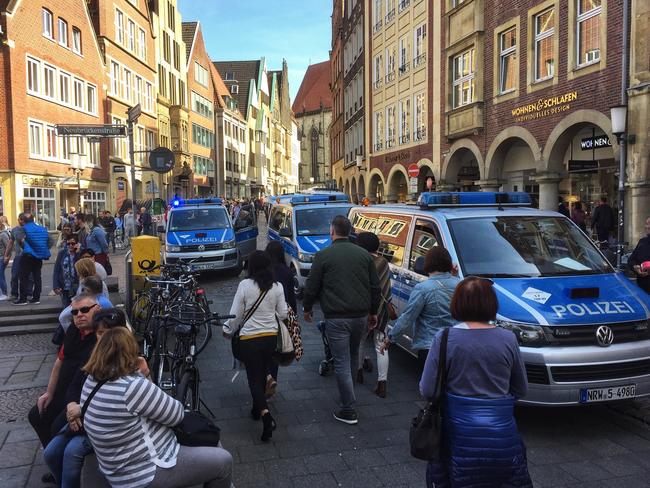 Pedestrians make their way through Muenster shortly after the attack. Picture: AP
