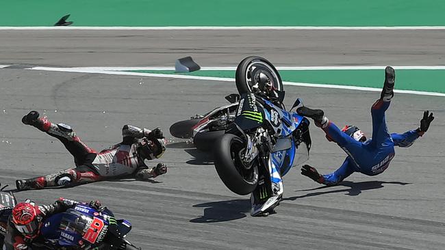 TOPSHOT – Honda LCR Japanese rider Takaaki Nakagami (L) and Suzuki Spanish rider Alex Rins (R) fall during the Moto Grand Prix de Catalunya at the Circuit de Catalunya on June 5, 2022 in Montmelo on the outskirts of Barcelona. (Photo by LLUIS GENE / AFP)