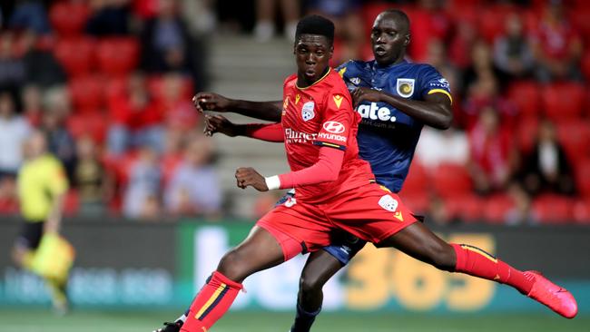 Adelaide’s Mohamed Toure is challenged by Central Coast’s Ruon Tongyik. Picture: AAP.