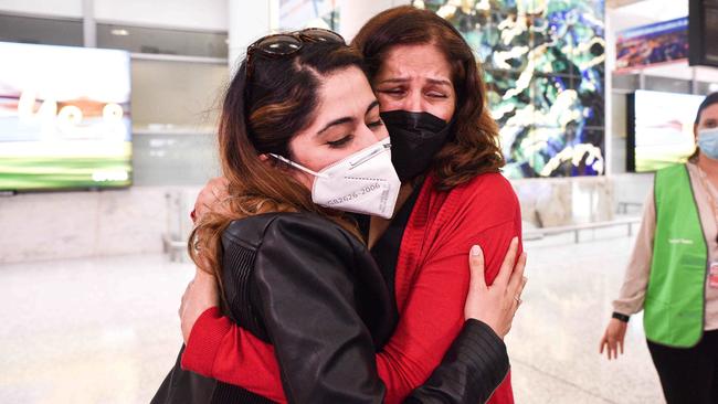 Loved ones reunite in Sydney after the first flight from Singapore touched down, signalling the start of the travel bubble. Picture: Flavio Brancaleone