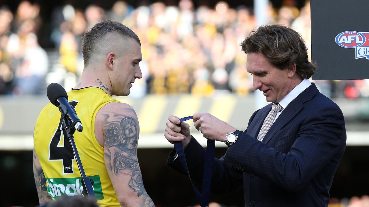 Dustin Martin gets the 2017 Norm Smith medal off James Hird. Photo: Michael Klein