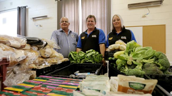 Rural Alive and Well (RAW) outreach workers Andrew Baker, left, Darren Thurlow and Kristy Mayne stocking up the food supplies for evacuees and firefighters at the Bothwell evacuation centre in the Central Highlands. Picture: PATRICK GEE