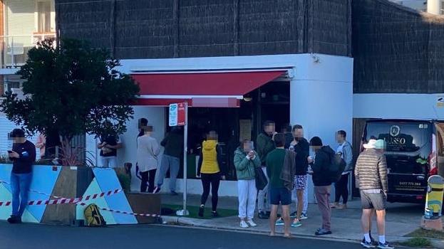 Patrons standing outside a North Bondi cafe.