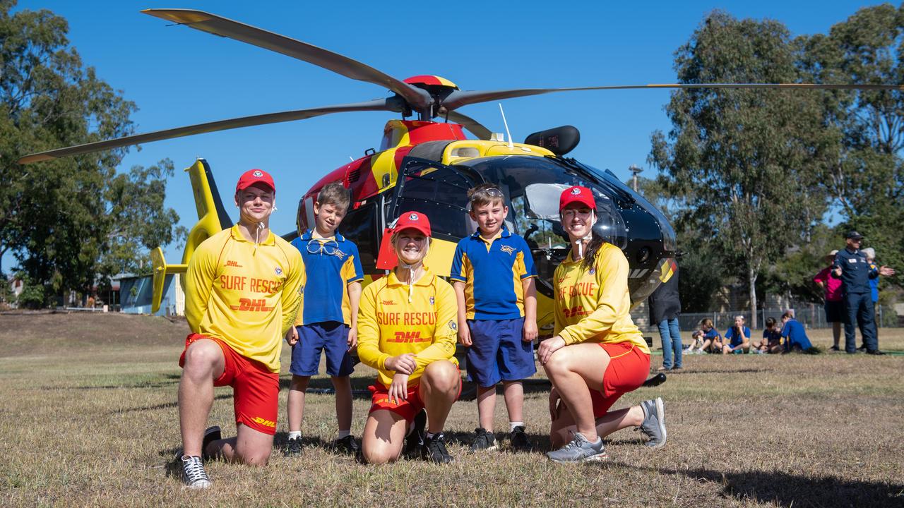 Mount Whitestone State School students Jacksin Grolimund and Nate Wakley, with Beach to Bush surf life savers, and the Westpac helicopter. PHOTO: ALI KUCHEL