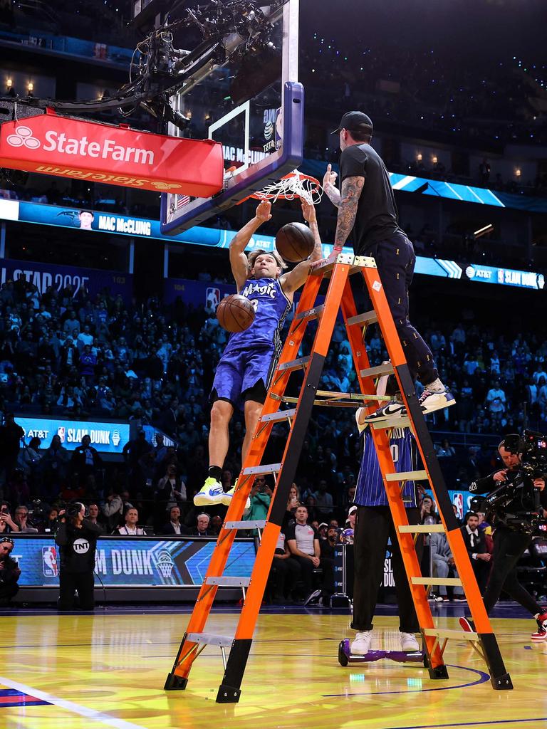 Over one guy and dunking two balls at once. Ezra Shaw/Getty Images/AFP