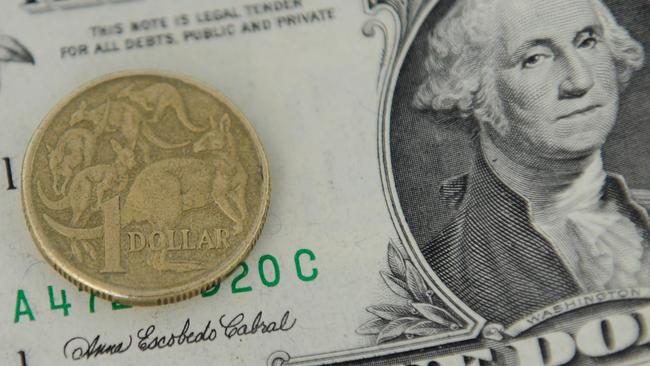 A 1 Australian Dollar coin and a 1 US Dollar note are seen in Canberra, Tuesday, May 21, 2013. As the US economy rebounds, there are predictions that the Australian dollar could fall as low as 90 US cents in the coming weeks and months. (AAP Image/Lukas Coch) NO ARCHIVING