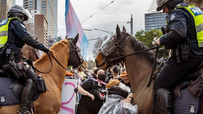 MELBOURNE, AUSTRALIA. NewsWire Photos. AUGUST 17, 2024. Mounted police hold back protesters from the Transgender Liberation group during a counter-protest against an anti-trans "women will speak" event at Parliament House Melbourne. Picture: NewsWire/Tamati Smith