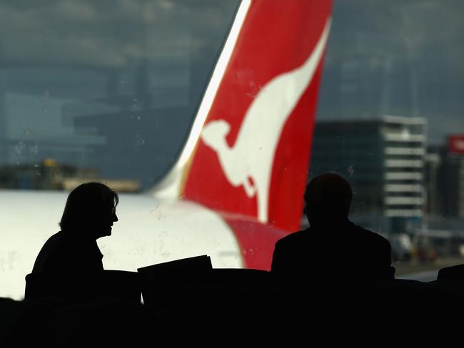 SYDNEY, AUSTRALIA - JUNE 21: Passangers wait at a Qantas departure gate as airlines cancel flights due to volcanic ash at Sydney Domestic Airport on June 21, 2011 in Sydney, Australia. Air travel across the country is being disrupted again, as a result of volcanic ash cloud from Chile inundating Australian air space. Sydney, Adelaide, Canberra and Melbourne airports have been affected, with all major airlines announcing cancellations. It is expected Brisbane airport will next be affected as the cloud travels over the east of the country. (Photo by Ryan Pierse/Getty Images)