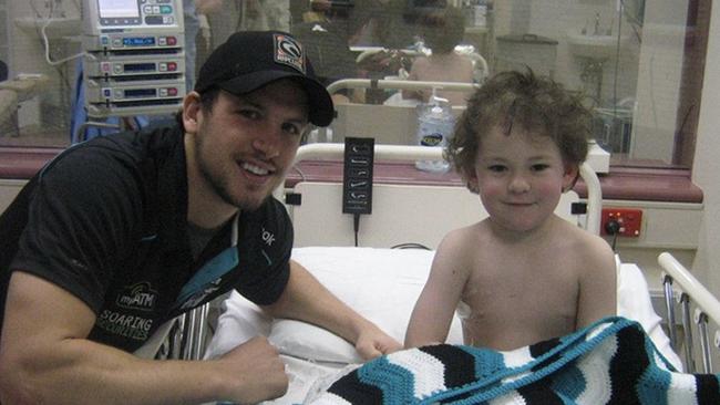 Travis Boak in hospital with a young Ryan Lane-Ellis. Picture: Supplied