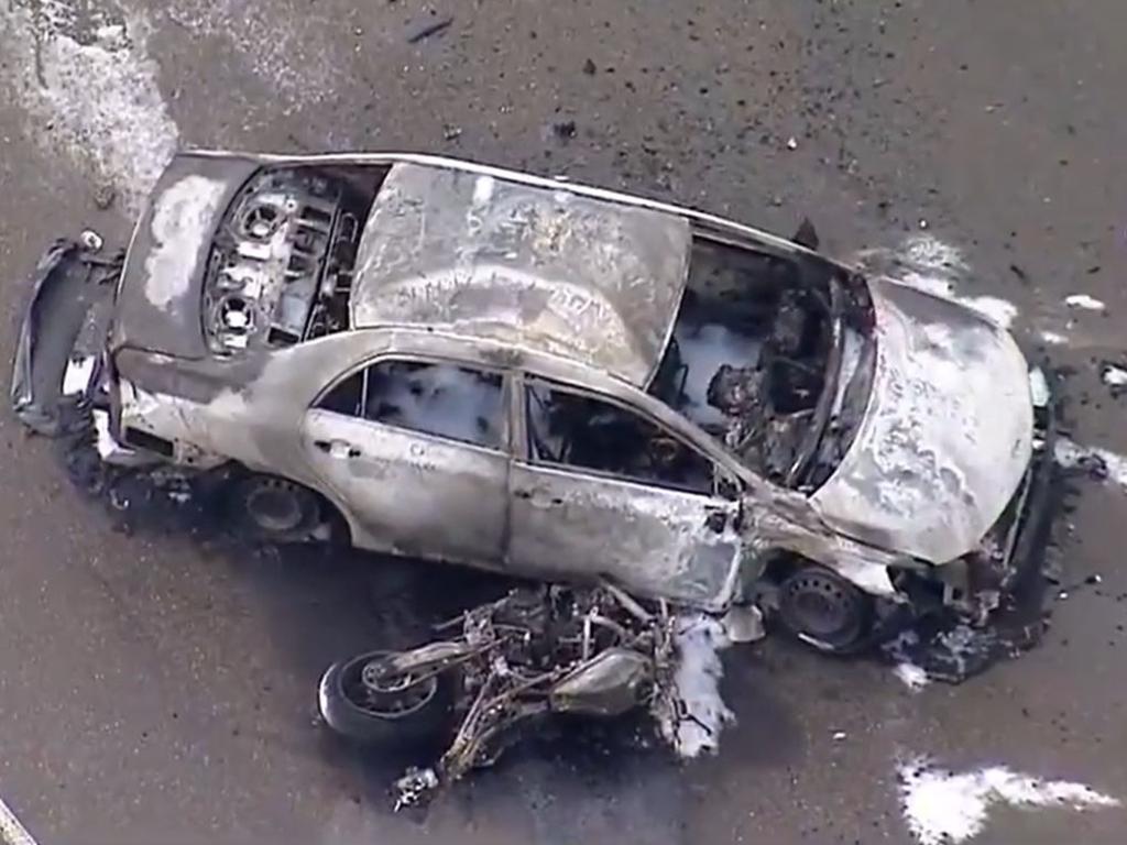 Two people have been hospitalised after a car and a motorbike collided in southwest Sydney before bursting into flames. Picture: Nine News