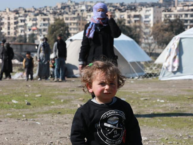 A child, displaced as a result of the earthquake that hit Turkey and Syria earlier this month, walks around a make shift camp in Bustan al-Qasr. Picture: AFP