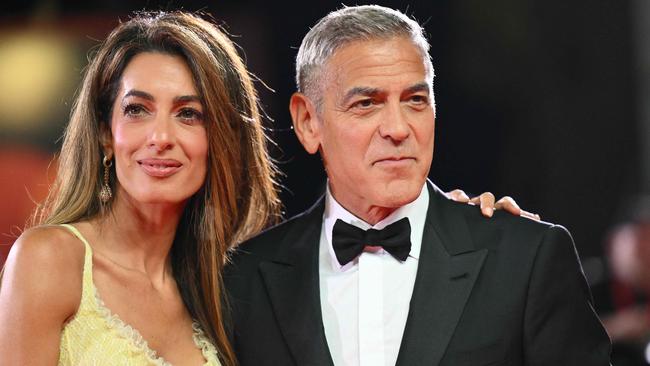 Actor George Clooney and his wife Amal Clooney attend the red carpet of the movie "Wolfs" presented out of competition during the 81st International Venice Film Festival at Venice Lido, on September 1, 2024. (Photo by Alberto PIZZOLI / AFP)