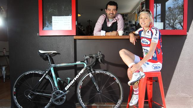 Pro cyclist Rachel Neylan at Red Berry Espresso with cafe owner Walter D'Addario. Photo: Tait Schmaal