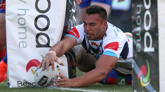 Ryan James of the Titans scores a try.