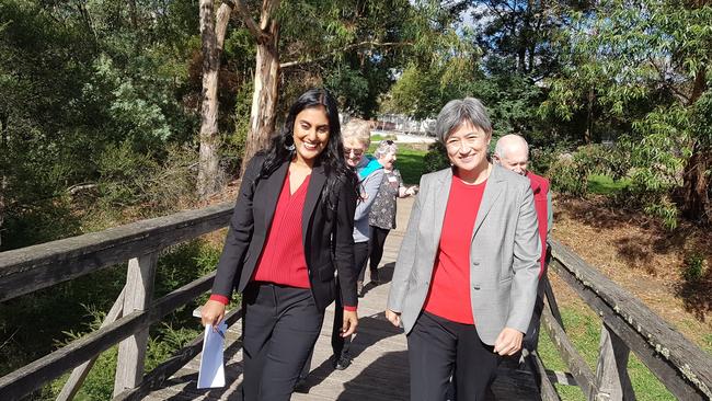 Labor's Deakin candidate Shireen Morris and Federal senate leader Penny Wong walk over Croydon's Tarralla Creek. Picture: Kiel Egging.