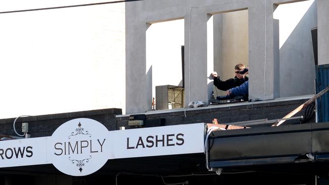 A rooftop DJ plays for the crowds on High St. Picture: Andrew Henshaw