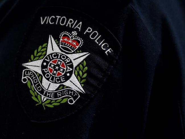 A Victorian Police badge is seen as approximately 275 kilograms of crystal methamphetamine is displayed at the Australian Federal Police offices in Melbourne, Monday, July, 4, 2016. A Victoria Joint Organised Crime Task Force (JOCTF) seized the methamphetamine with a street value of $275 million after identifying the syndicate in February, arresting one Malaysian and seven Australians. This is the biggest seizure in Victoria this year. (AAP Image/Tracey Nearmy) NO ARCHIVING