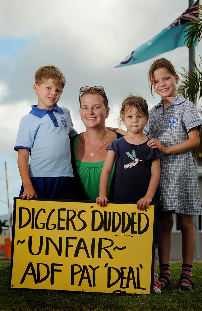 Protesting outside the RAAF base in Townsville ... Oscar, 7, Cayce, Miranda, 3 and Matilda, 8 support defence workers including their father over the effective pay cut.