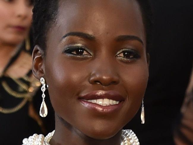 Actress Lupita Nyong'o poses on the red carpet for the 87th Oscars on February 22, 2015 in Hollywood, California. Local media are reporting that the Los Angles Sheriff's office is invetigating the February 26, 2015, theft of Nyong's's Oscar dress worth an estimated 150,000 USD. Sheriff's office officials say the dress with 6,000 peals was reported stolen from the London West Hollywood Hotel. AFP PHOTO / MLADEN ANTONOV