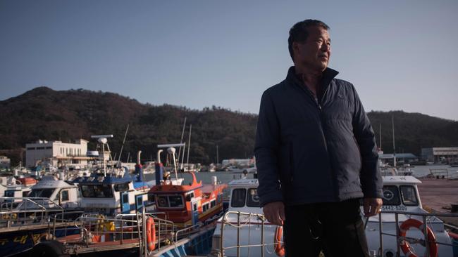 Hire boat captain Park Tae-Il stands before his vessel at a small fishing port adjacent to Paengmok harbour on South Korea's southern island of Jindo. Picture: Ed Jones/AFP