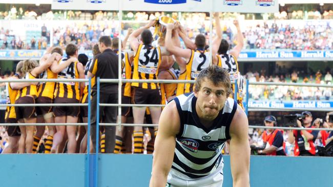 28/09/2008 LIBRARY: AFL football - Geelong vs Hawthorn Grand Final match at the MCG. Footballer Corey Enright struggles to get up off the ground as the Hawthorn team receive the premiership cup.