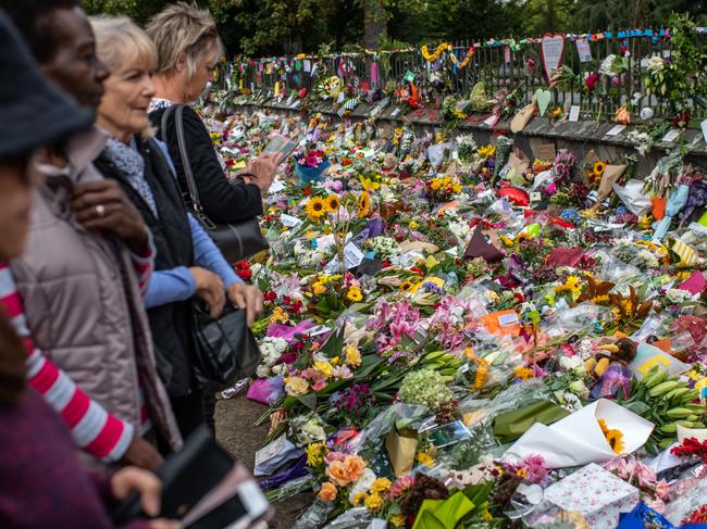 People view flowers and tributes placed by the Botanical Gardens in Christchurch. 