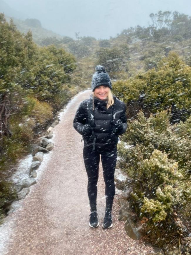 Sara Dixley of Perth visiting Tasmania with partner Paul Erlynne at Cradle Mountain in the snow. Picture: Paul Erlynne