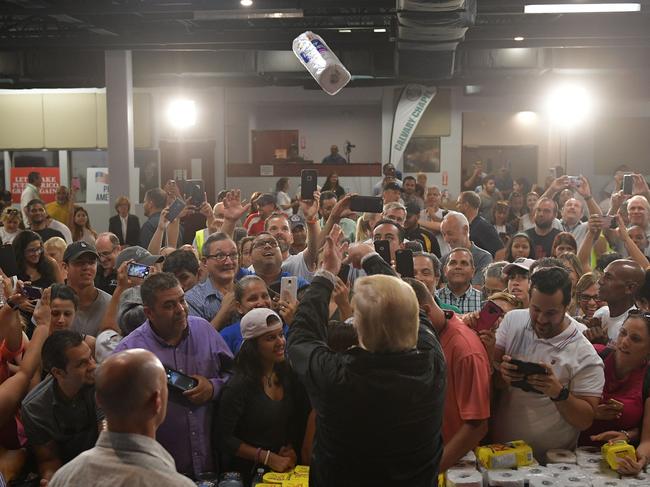 Donald Trump throws a paper towel roll as he visits the Cavalry Chapel in Guaynabo, Puerto Rico, nearly two weeks after Hurricane Maria thrashed through the US territory leaving much of the islands remains short of food and without access to power or drinking water. Picture: AFP