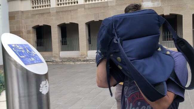 Patricia Davis stuck her head inside a backpack to hide from the media on January 28. Picture: Madeline Crittenden.