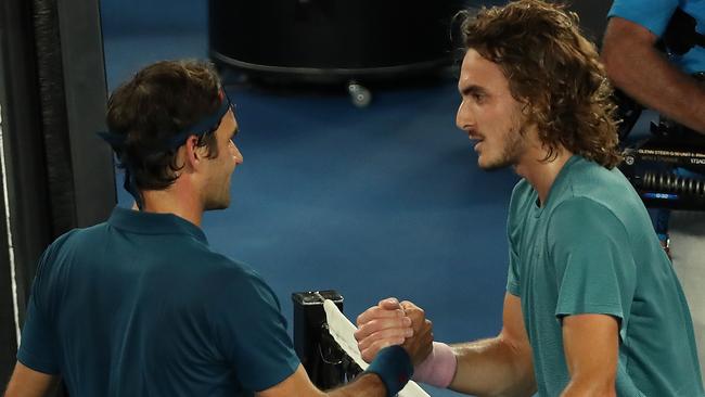 Stefanos Tsitsipas of Greece (right) shakes hands with Roger Federer of Switzerland after winning the match on day seven of the Australian Open tennis tournament in Melbourne.