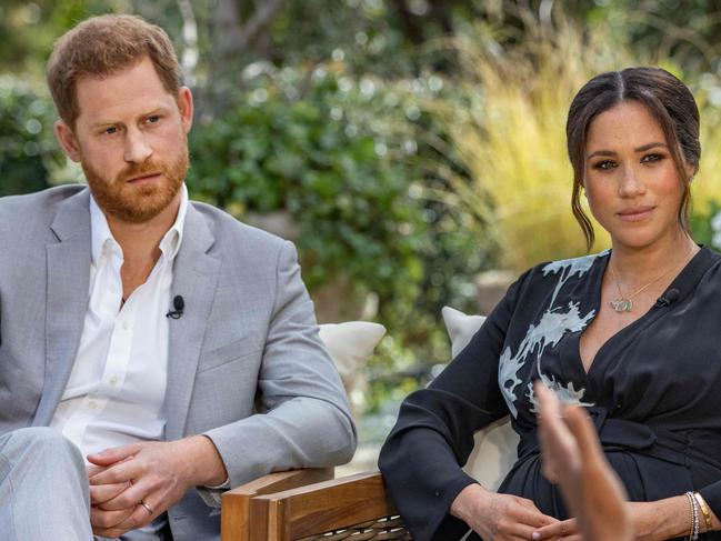 This undated image released March 7, 2021 courtesy of Harpo Productions shows Britain's Prince Harry (L) and his wife Meghan (C), Duchess of Sussex, in a conversation with US television host Oprah Winfrey. - Britain's royal family on March 7, 2021 braced for further revelations from Prince Harry and his American wife, Meghan, as a week of transatlantic claim and counter-claim reaches a climax with the broadcast of their interview with Oprah Winfrey. The two-hour interview with the US TV queen is the biggest royal tell-all since Harry's mother princess Diana detailed her crumbling marriage to his father Prince Charles in 1995. (Photo by Joe PUGLIESE / HARPO PRODUCTIONS / AFP) / RESTRICTED TO EDITORIAL USE - MANDATORY CREDIT "AFP PHOTO/ HARPO PRODUCTIONS -  Joe PUGLIESE" - NO MARKETING NO ADVERTISING CAMPAIGNS - DISTRIBUTED AS A SERVICE TO CLIENTS --- NO ARCHIVE ---