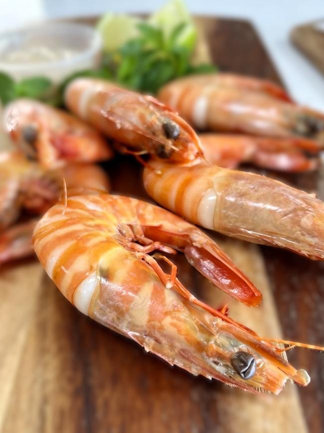 Bec Zaghini, owner of Wild Local seafood supplier and gourmet fish-and-chip restaurant, says the locally sourced tiger prawns, served here with a salad and home-made seafood sauce, is a favourite. Picture: Cameron Bates