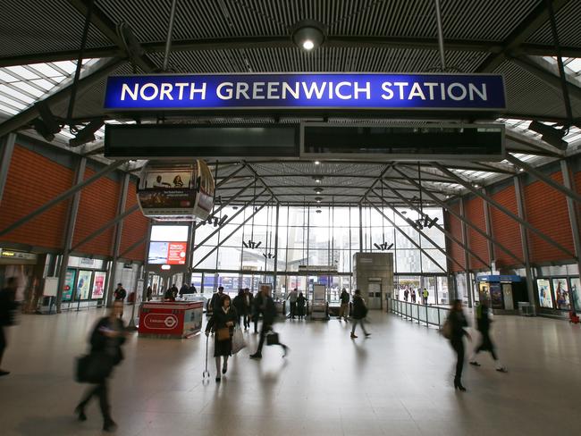 Passengers walk through the forecourt at North Greenwich London Underground station in London.