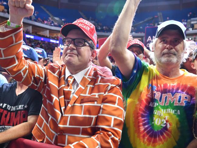 (FILES) In this file photo supporters Blake Marnell(L) and others cheer as they listen to US President Donald Trump speak during a campaign rally at the BOK Center on June 20, 2020 in Tulsa, Oklahoma. - The number of new COVID-19 cases in the United States is hitting levels not seen since the early part of the pandemic in April.  A patchwork of responses at the official level, the politicization of masks and physical distancing, and the widespread onset of complacency are to blame. (Photo by Nicholas Kamm / AFP)