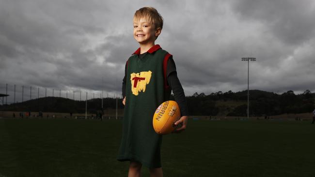 Jenson Peterson 5 wearing his grandfather’s (Robert Dykes) Tasmanian state playing jumper. Tasmanian kids from across the state have been able to get in the Devils spirit at the Tasmania Football Club school holiday clinics. Picture: Nikki Davis-Jones