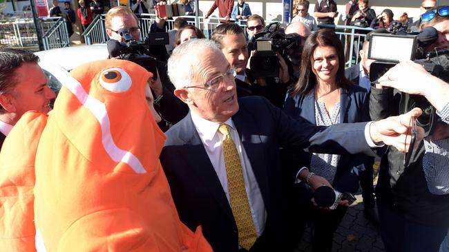 Salty selfie: Prime Minister Malcolm Turnbull and Mayo Liberal MP Jamie Briggs take a selfie with Nemo the fish during a street walk in Stirling. Picture: AAP Image/Lukas Coch