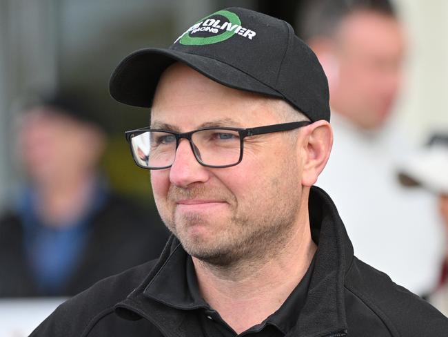 MELBOURNE, AUSTRALIA - JULY 17: Trainer Luke Oliver poses after Justdoit won Race 5, the Tobin Brothers Celebrating Lives - Betting Odds during Melbourne Racing at Sandown Lakeside Racecourse on July 17, 2024 in Melbourne, Australia. (Photo by Vince Caligiuri/Getty Images)