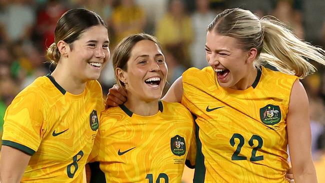 MELBOURNE, AUSTRALIA - FEBRUARY 28: Kyra Cooney-Cross of Australia, Katrina Gorry of Australia and Charlotte Grant of Australia celebrate after winning the AFC Women's Olympic Football Tournament Paris 2024 Asian Qualifier Round 3 match between Australia Matildas and Uzbekistan at Marvel Stadium on February 28, 2024 in Melbourne, Australia. (Photo by Robert Cianflone/Getty Images)