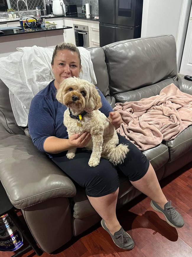 Family friend Erinn took care of the cavoodle while Nathaniel was in hospital. The small dog was left with bite injuries after an “unprovoked” attack in Hope Island. Picture: Facebook