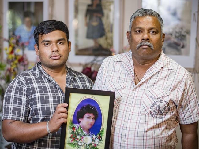 Wish and his father Priyantha Somawansa in front of a vigil and photos of their mum who was killed. Picture: Jason Edwards