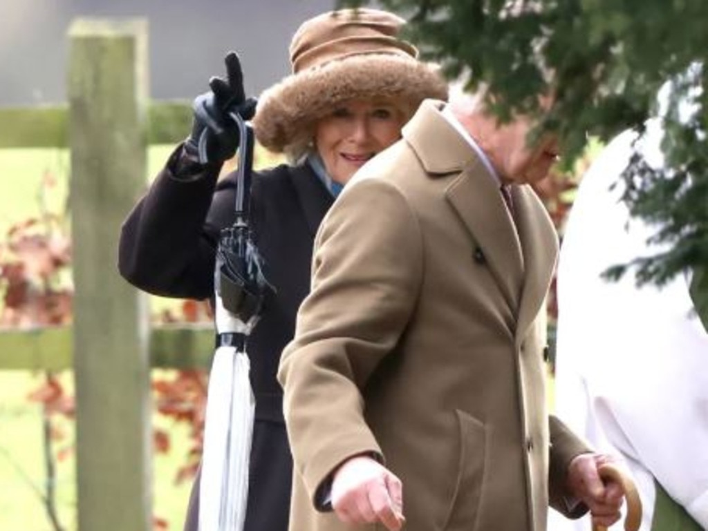 Queen Camilla waves as she joined King Charles at a church service in Sandringham. Picture: AFP