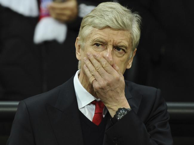 Arsenal's manager Arsene Wenger covers his face prior to the first leg of the Champions League round of 16 soccer match between Bayern Munich and FC Arsenal in the Allianz Arena in Munich, Germany, Wednesday, Feb. 15 , 2017. (Sven Hoppe/dpa via AP)