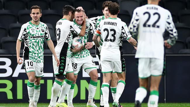 Besart Berisha is mobbed by his Western United teammates after scoring against Perth Glory. Picture: Cameron Spencer/Getty Images