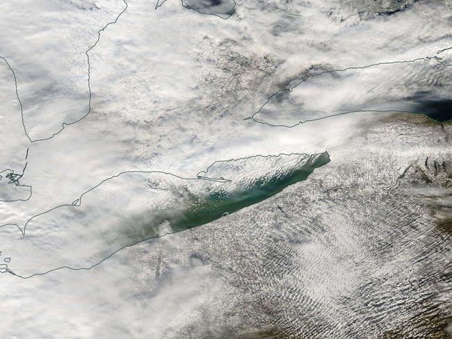 NASA satellite photo shows cloud bands over the snow-buried state.