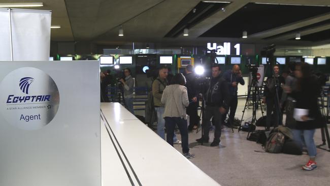 Reporters gather in front of the EgyptAir counter at Charles de Gaulle Airport outside of Paris.
